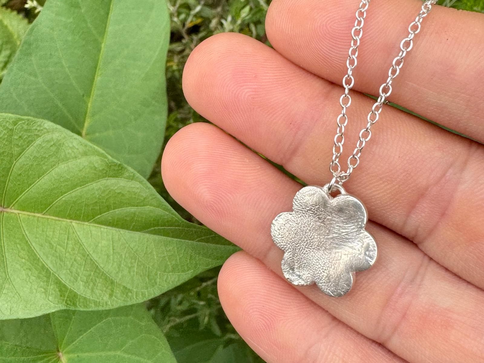 Close-up of a heart-shaped pendant showing print texture